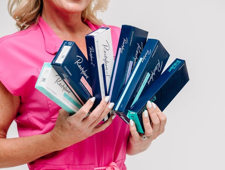 Holding a fan of Restylane filler boxes