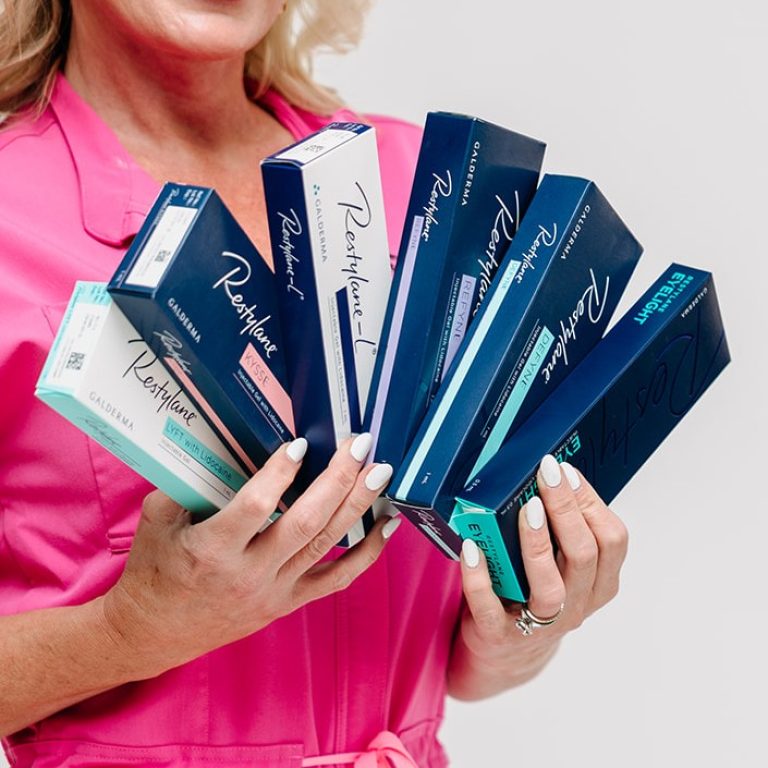 Holding a fan of Restylane filler boxes